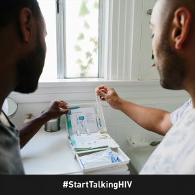 Image displays two men opening an at-home HIV test kit.