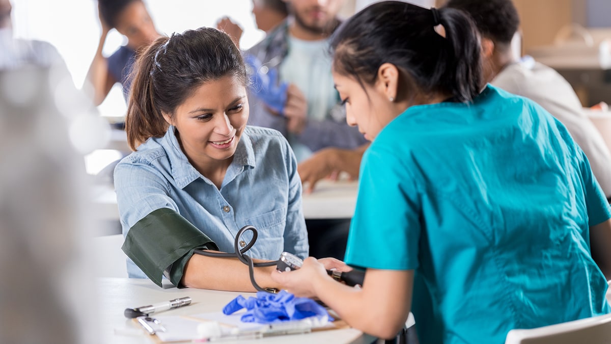 A woman getting her blood pressure checked.