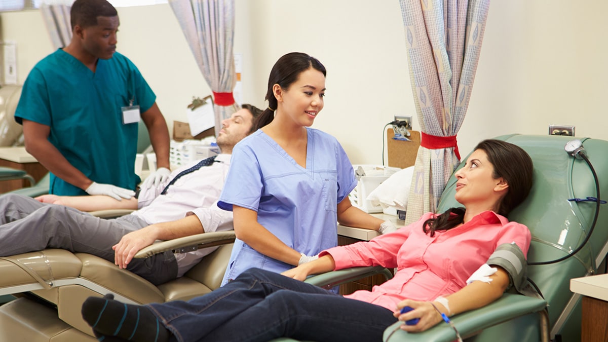 Doctors talking to patients giving blood