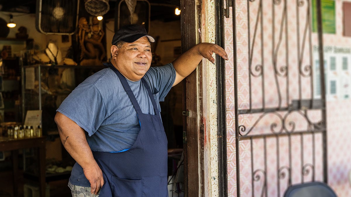 Man standing in the doorway of a rural business