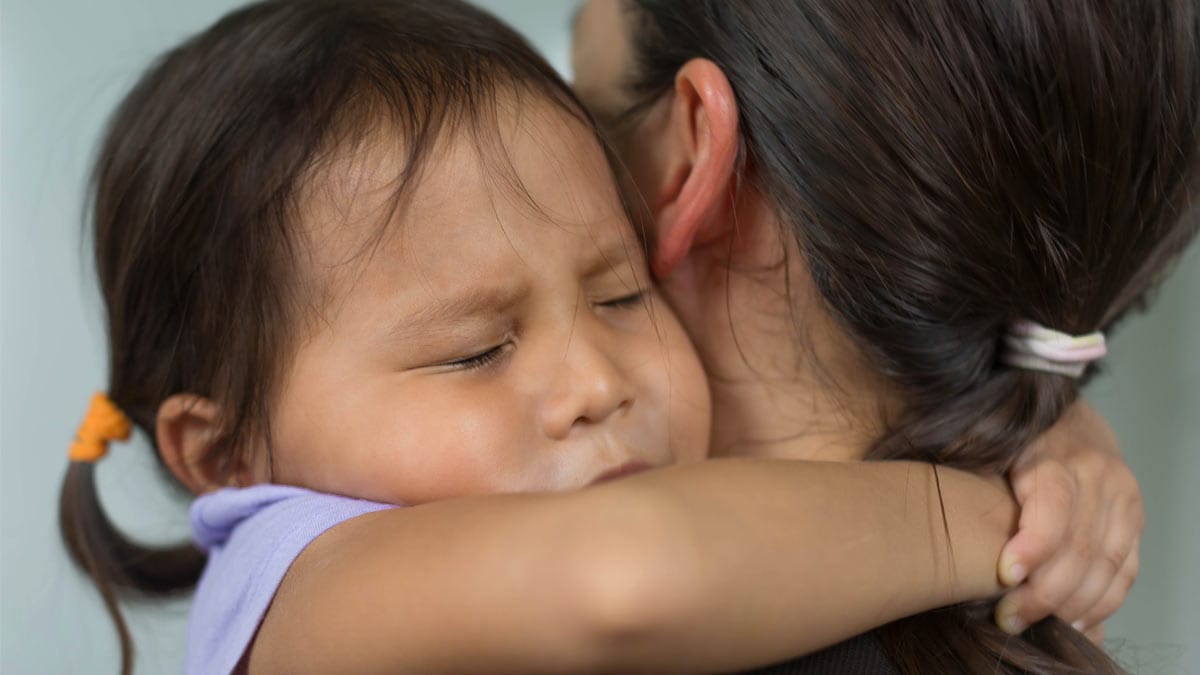 Child hugging parent.