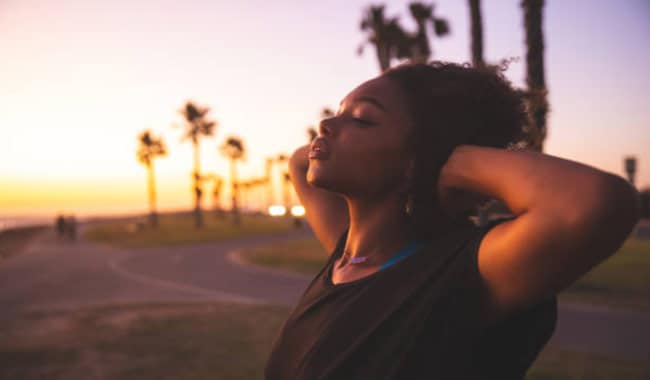 Woman relaxing by taking deep breath.