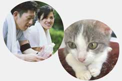 man and woman with towels and water bottle from exercising and a grey and white kitten