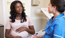 Doctor consulting pregnant patient