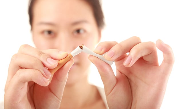 woman breaking a cigarette