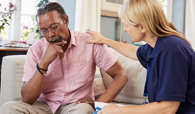 A therapist comforting a patient who has depression.