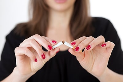 Image of a person breaking a cigarette