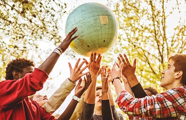 Teenagers reaching to touch the world