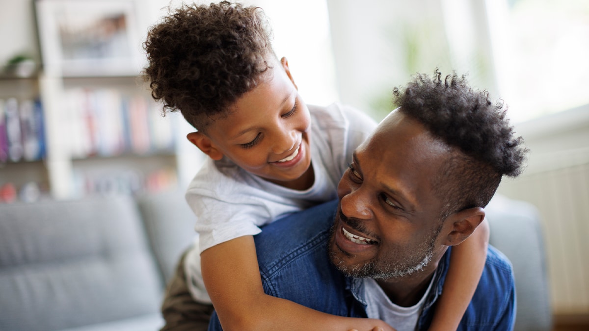 Father and son embracing at home