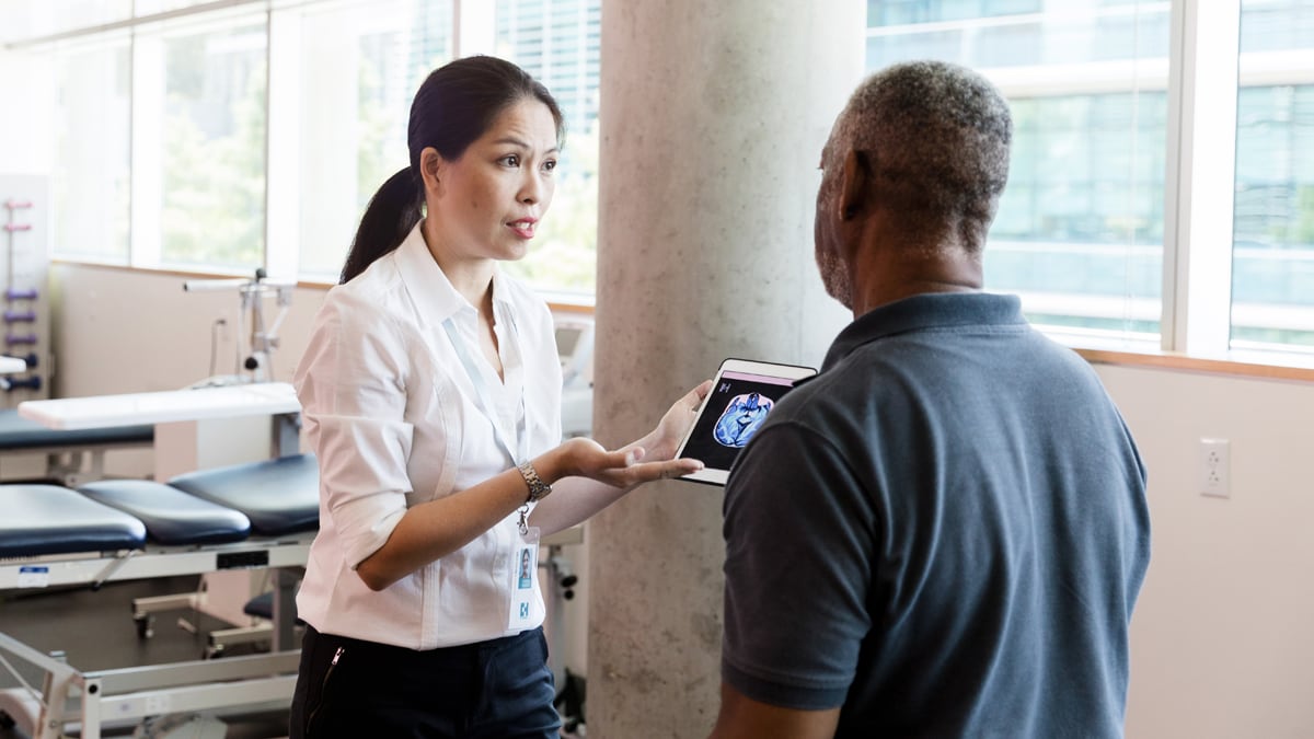 Healthcare provider shows a screen to a patient