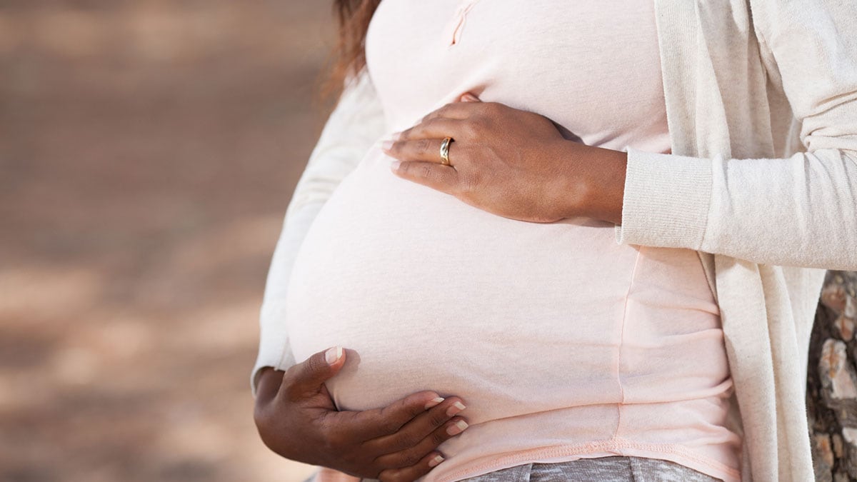 Pregnant woman holding belly