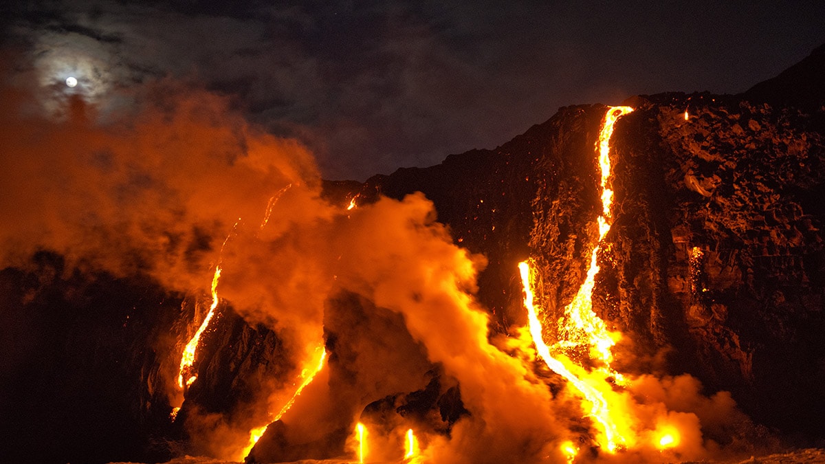 Red hot lava and ash spewing from an active volcano.